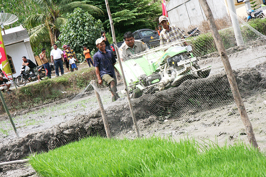 Mr. Elianor Sembiring tries a planting machine during its demonstration trial at Perbulan Village of Kabanjahe District of Indonesia.