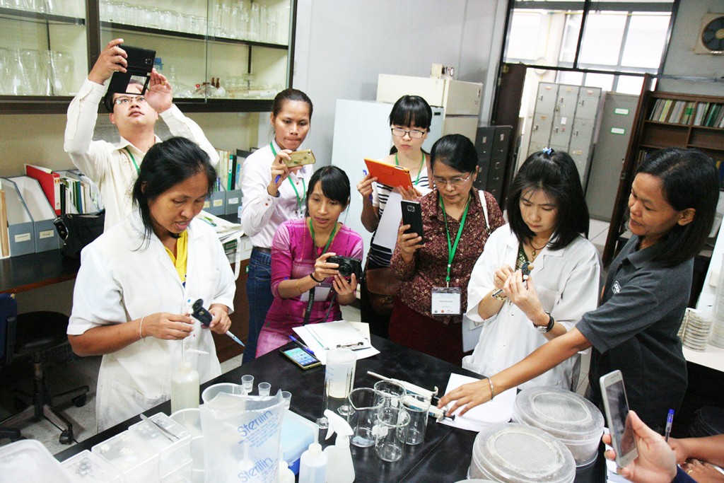 Ms. Neur learns about laboratory techniques at the training along with other participants from Lao PDR, Myanmar, and Vietnam.