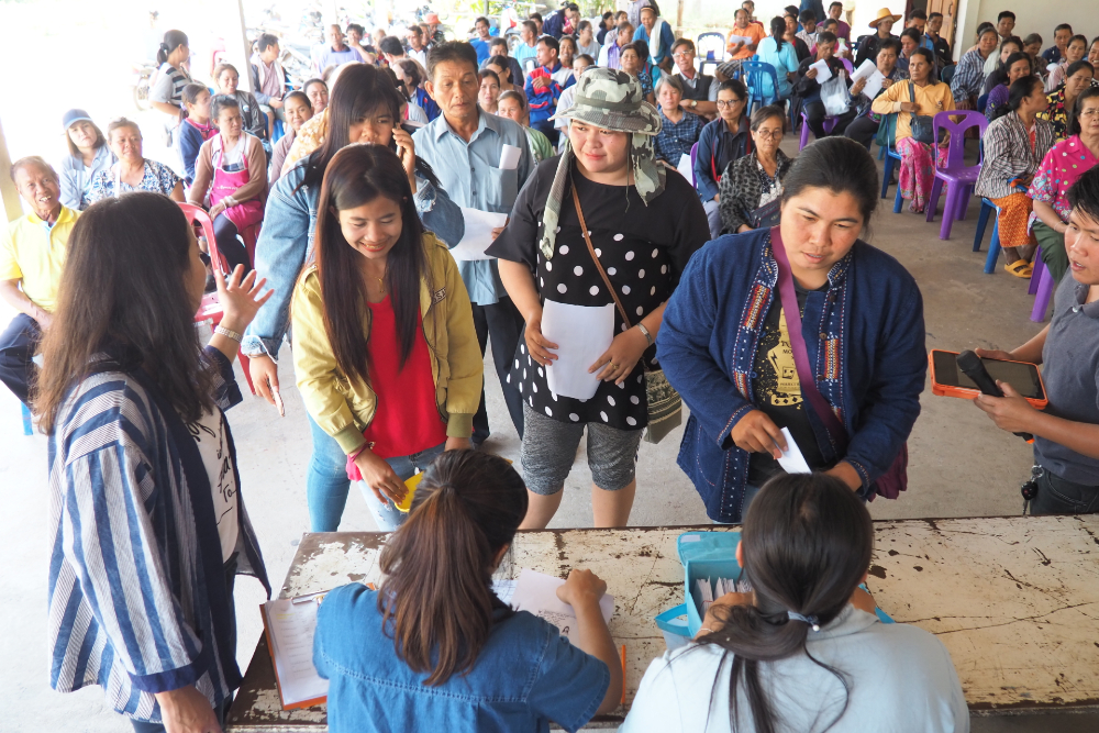 Local farmers have their ID cards checked before receiving the bonuses. (Photo credit: GIZ Thailand)